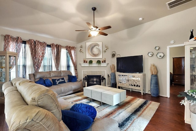 1942 Garrison Way, Garland, TX 75040 - living area with ceiling fan, a tiled fireplace, dark wood-type flooring, and vaulted ceiling