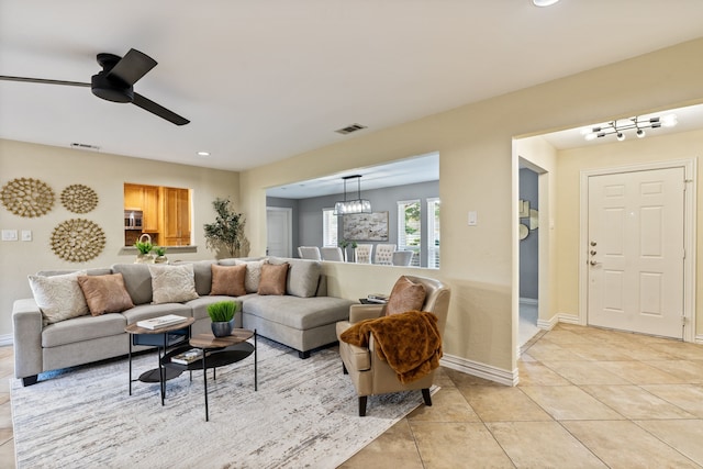3644 Courtdale Dr, Farmers Branch, TX 75234 - living room with light tile patterned floors, recessed lighting, ceiling fan, baseboards, and a chandelier