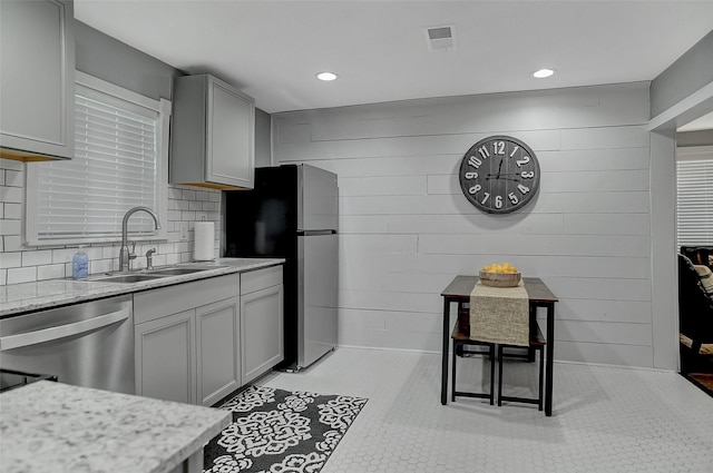 514 W Baker St, Denison, TX 75020 - kitchen with a sink, stainless steel appliances, gray cabinets, recessed lighting, and decorative backsplash