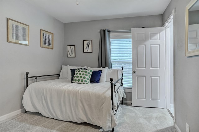 514 W Baker St, Denison, TX 75020 - bedroom with light colored carpet and baseboards