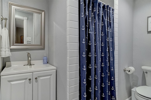 514 W Baker St, Denison, TX 75020 - bathroom with toilet, a shower with shower curtain, and vanity