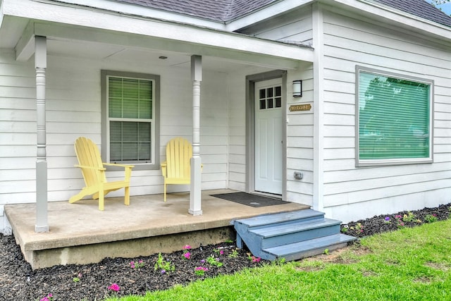 514 W Baker St, Denison, TX 75020 - doorway to property featuring covered porch and roof with shingles