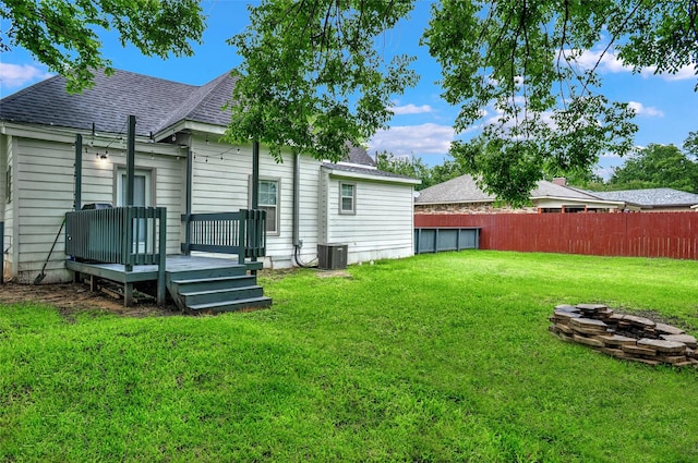 514 W Baker St, Denison, TX 75020 - rear view of property featuring a shingled roof, a wooden deck, and central air condition unit