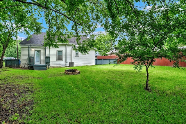 514 W Baker St, Denison, TX 75020 - view of yard with central AC unit and a fire pit