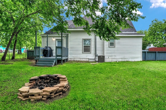 514 W Baker St, Denison, TX 75020 - rear view of house featuring an outdoor fire pit, roof with shingles, a deck, and central AC