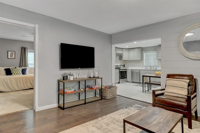 514 W Baker St, Denison, TX 75020 - living area with hardwood / wood-style flooring, healthy amount of natural light, and baseboards