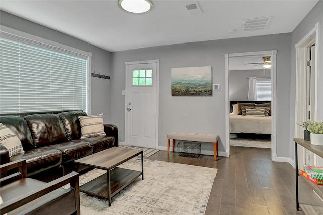 514 W Baker St, Denison, TX 75020 - living area featuring dark wood finished floors, baseboards, and a ceiling fan