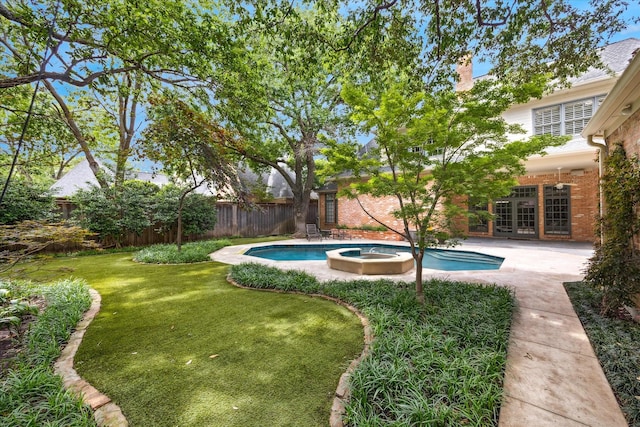 view of pool featuring french doors, a pool with connected hot tub, and a patio