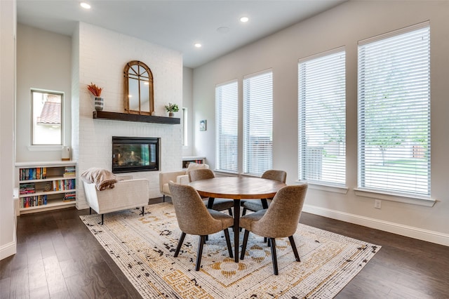 2813 Dorset, The Colony, TX 75056 - dining room featuring baseboards, dark wood-type flooring, a fireplace, and recessed lighting