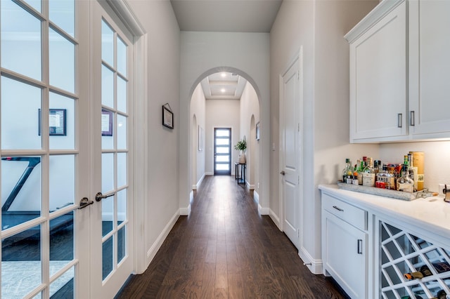 2813 Dorset, The Colony, TX 75056 - corridor featuring arched walkways, dark wood-type flooring, and baseboards