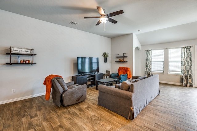 5712 Demi Sec Dr, Mckinney, TX 75070 - living room with lofted ceiling, wood finished floors, ceiling fan, arched walkways, and baseboards