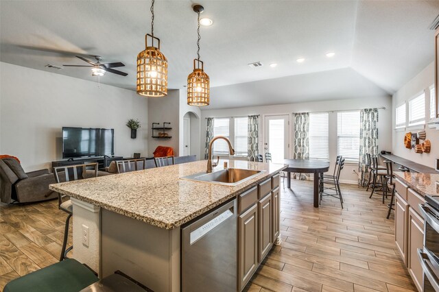 5712 Demi Sec Dr, Mckinney, TX 75070 - kitchen featuring a sink, stainless steel dishwasher, light wood-type flooring, open floor plan, and plenty of natural light