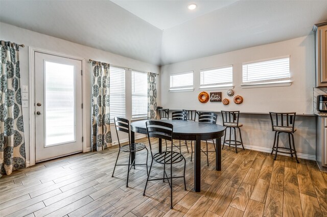 5712 Demi Sec Dr, Mckinney, TX 75070 - dining room featuring wood finished floors, baseboards, and vaulted ceiling