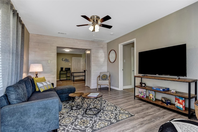 401 W Acheson St, Denison, TX 75020 - living area with wood finished floors, ceiling fan, wooden walls, and baseboards