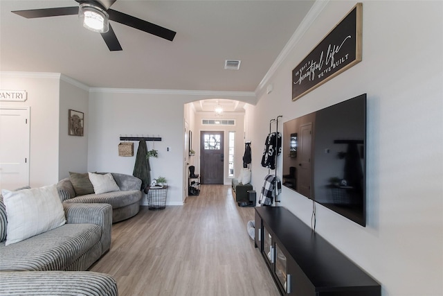 816 Killam Dr, Temple, TX 76502 - living area featuring arched walkways, ceiling fan, crown molding, light wood-style flooring, and baseboards