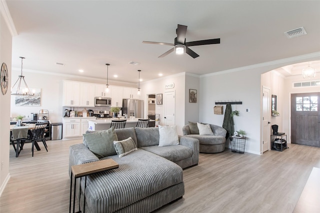 816 Killam Dr, Temple, TX 76502 - living area with light wood-style flooring, a chandelier, arched walkways, recessed lighting, and baseboards