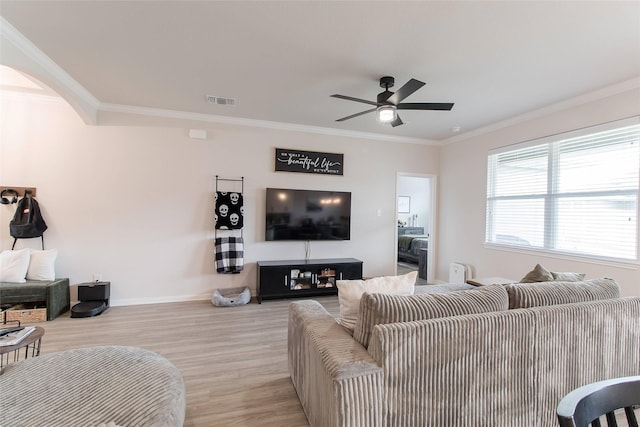 816 Killam Dr, Temple, TX 76502 - living area with light wood-style floors, arched walkways, baseboards, ceiling fan, and crown molding