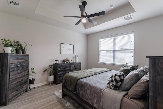 816 Killam Dr, Temple, TX 76502 - bedroom featuring a raised ceiling, light wood-style flooring, baseboards, and a ceiling fan