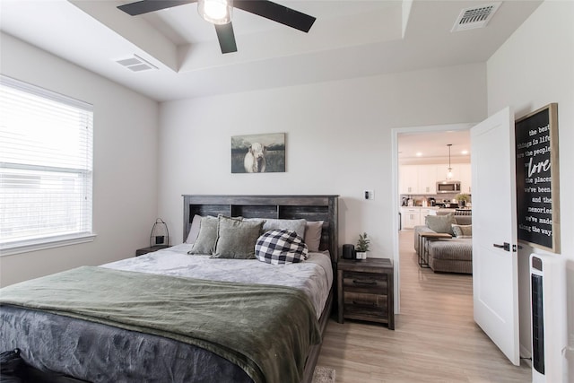 816 Killam Dr, Temple, TX 76502 - bedroom featuring a raised ceiling, light wood finished floors, and ceiling fan