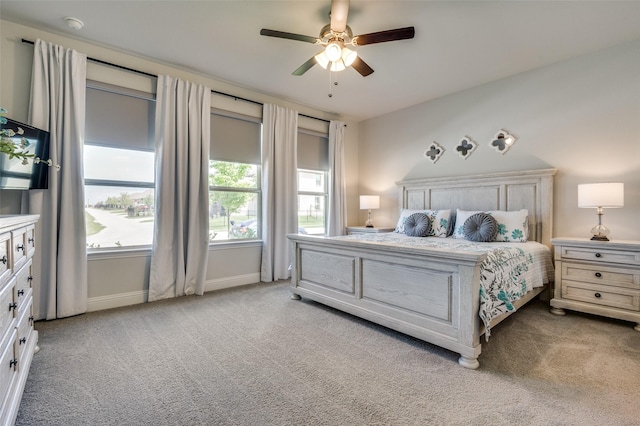 carpeted bedroom with baseboards and ceiling fan