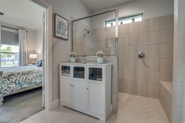 bathroom featuring connected bathroom, walk in shower, healthy amount of natural light, and tile patterned flooring