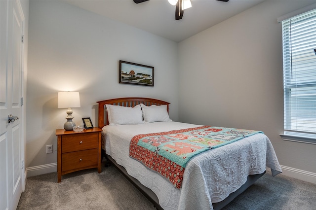 carpeted bedroom with multiple windows, baseboards, and ceiling fan