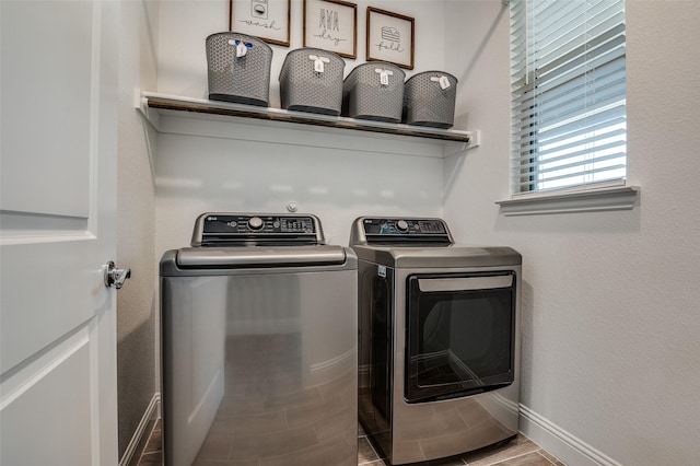 washroom with independent washer and dryer, baseboards, and wood finished floors