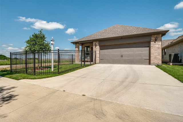 view of front facade featuring brick siding, fence, concrete driveway, a garage, and central air condition unit