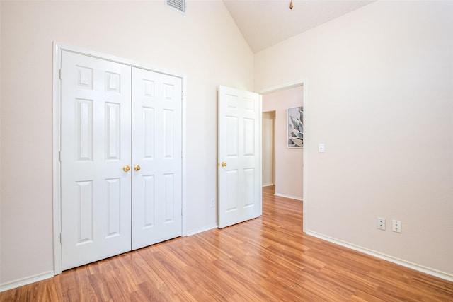 3104 Ridge Hollow Dr, Plano, TX 75023 - unfurnished bedroom featuring light wood-style flooring, baseboards, high vaulted ceiling, and a closet