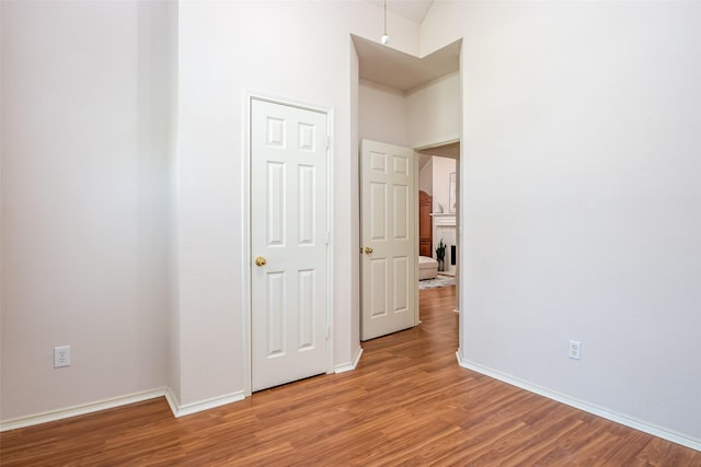 3104 Ridge Hollow Dr, Plano, TX 75023 - unfurnished bedroom with wood finished floors, baseboards, and high vaulted ceiling