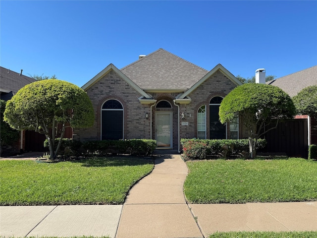 3104 Ridge Hollow Dr, Plano, TX 75023 - view of front of home with a front lawn, brick siding, and a shingled roof