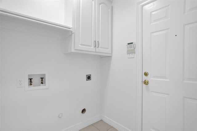 clothes washing area featuring washer hookup, hookup for an electric dryer, cabinet space, baseboards, and light tile patterned floors