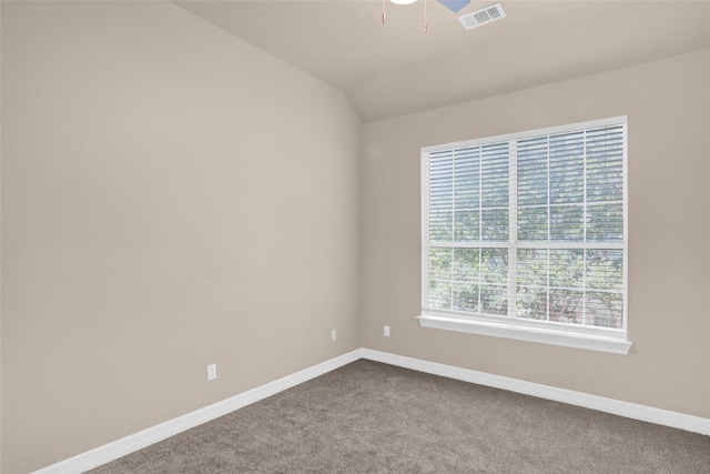 empty room with dark colored carpet, baseboards, ceiling fan, and lofted ceiling