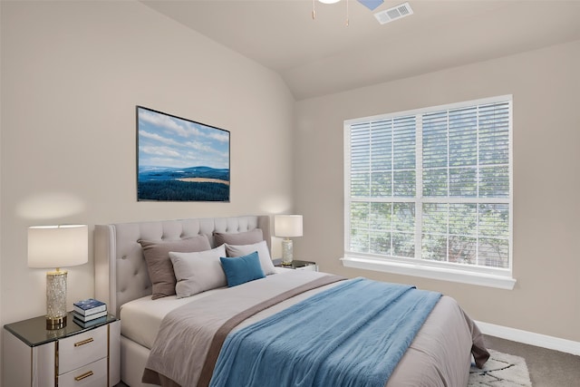 carpeted bedroom with baseboards and lofted ceiling