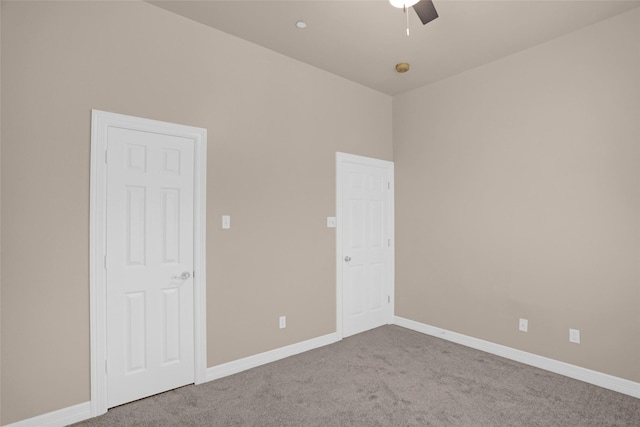 unfurnished bedroom featuring carpet floors, baseboards, and ceiling fan