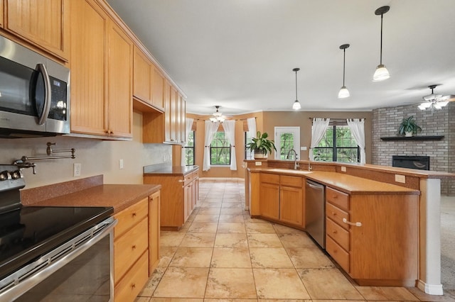146 Country Oaks Rd, Clyde, TX 79510 - kitchen with appliances with stainless steel finishes, a ceiling fan, a sink, a fireplace, and open floor plan