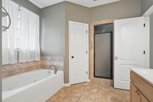 146 Country Oaks Rd, Clyde, TX 79510 - bathroom with tile patterned floors, a jetted tub, vanity, and a stall shower