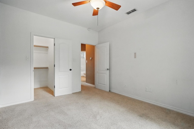 146 Country Oaks Rd, Clyde, TX 79510 - unfurnished bedroom featuring light carpet, a spacious closet, baseboards, a closet, and a ceiling fan