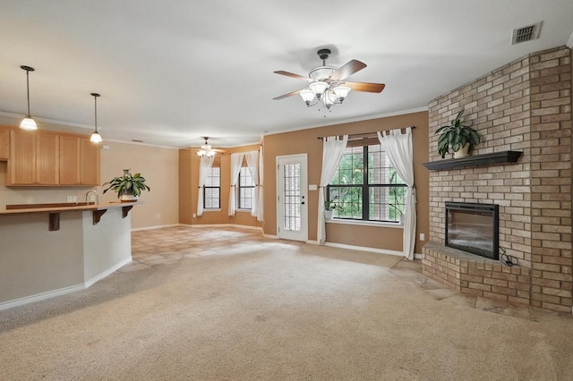 146 Country Oaks Rd, Clyde, TX 79510 - unfurnished living room with light colored carpet, ceiling fan, baseboards, a fireplace, and crown molding