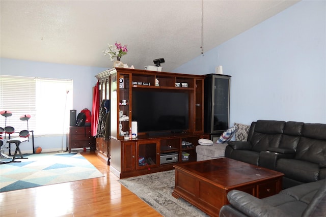 living area featuring light wood-style floors and lofted ceiling