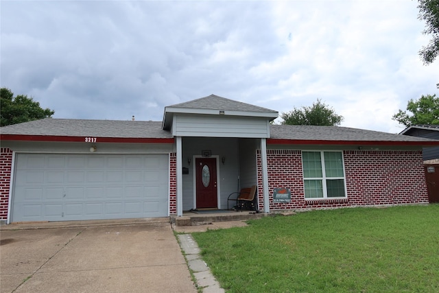 ranch-style house featuring concrete driveway, a front yard, brick siding, a garage, and roof with shingles