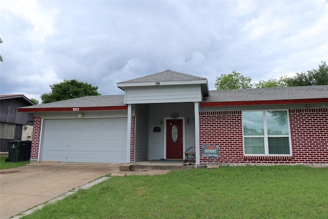 ranch-style home with an attached garage, concrete driveway, a front lawn, brick siding, and roof with shingles