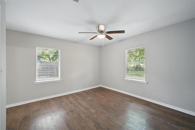 2906 W Parnell St, Denison, TX 75020 - empty room featuring healthy amount of natural light, dark wood finished floors, ceiling fan, and baseboards