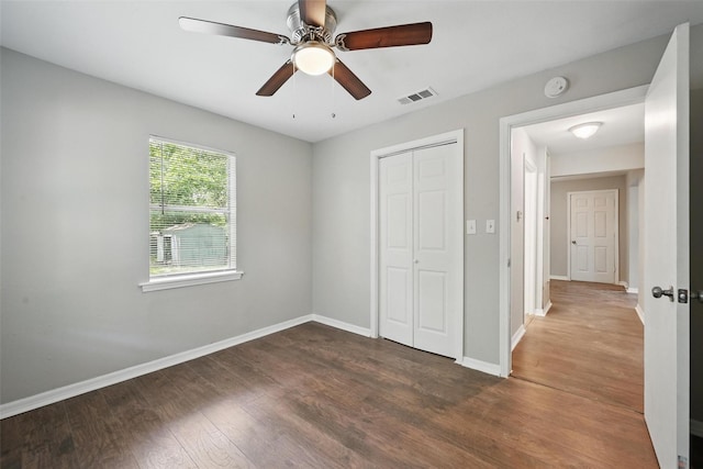 2906 W Parnell St, Denison, TX 75020 - unfurnished bedroom with a closet, dark wood-type flooring, baseboards, and ceiling fan