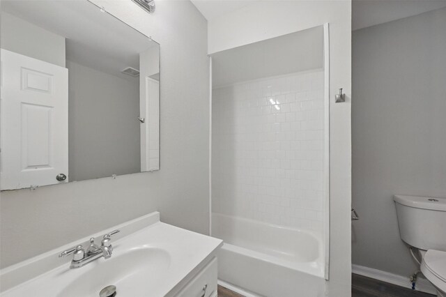 2906 W Parnell St, Denison, TX 75020 - bathroom featuring toilet, vanity, and washtub / shower combination