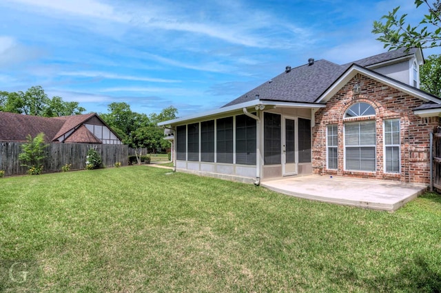 2116 Landau Ln, Bossier City, LA 71111 - back of house featuring a sunroom, a patio area, roof with shingles, and brick siding