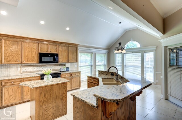 2116 Landau Ln, Bossier City, LA 71111 - kitchen featuring black appliances, a center island with sink, a sink, tasteful backsplash, and light tile patterned floors