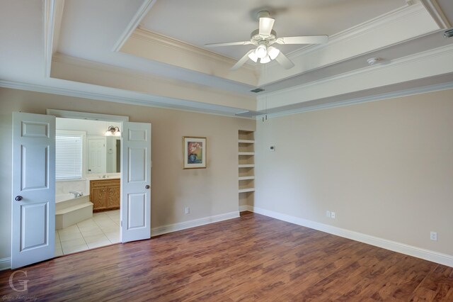2116 Landau Ln, Bossier City, LA 71111 - unfurnished bedroom featuring a raised ceiling, wood finished floors, crown molding, connected bathroom, and ceiling fan