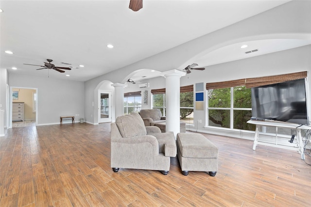 270 Hawk Ln, Brownwood, TX 76801 - living room with decorative columns, a ceiling fan, arched walkways, wood finished floors, and recessed lighting