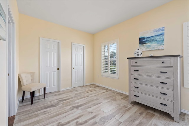 270 Hawk Ln, Brownwood, TX 76801 - bedroom with multiple closets, light wood-type flooring, and baseboards